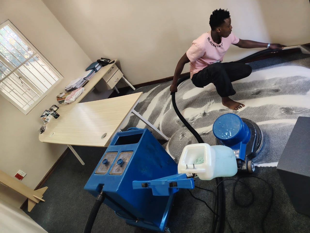 Rug cleaning in progress photographed during an Estlas job